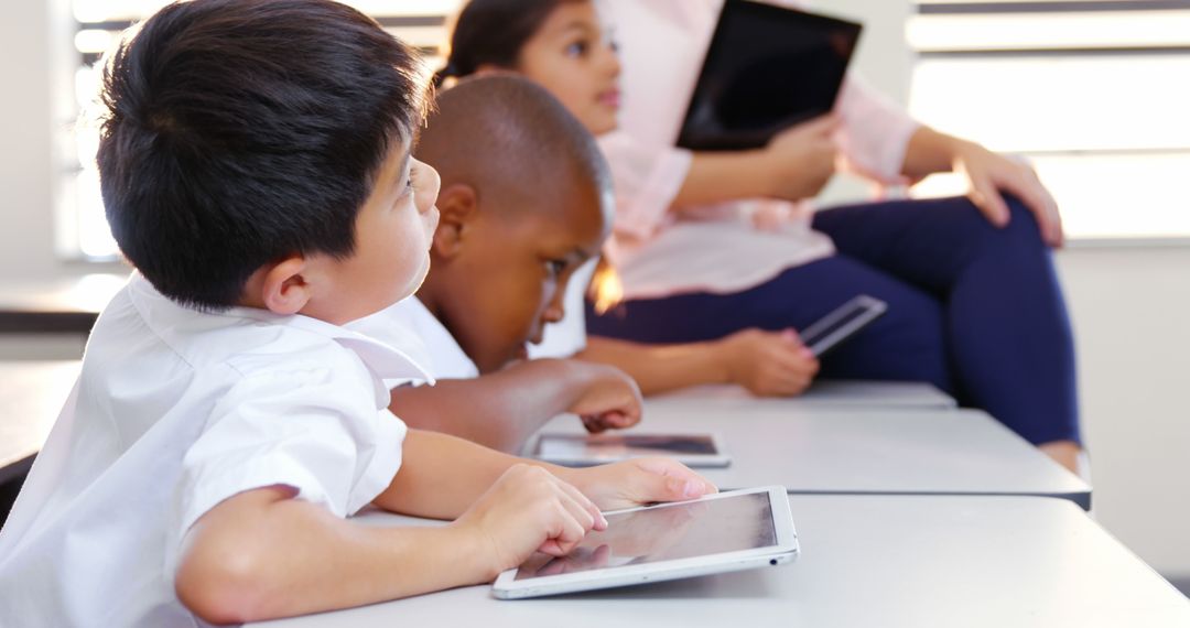 Young Students Learning with Tablets in Classroom - Free Images, Stock Photos and Pictures on Pikwizard.com