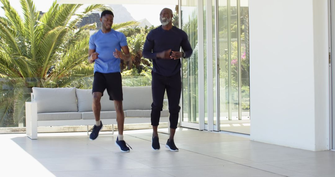 Father and Son Enjoy Outdoor Cardio Together on Modern Patio
