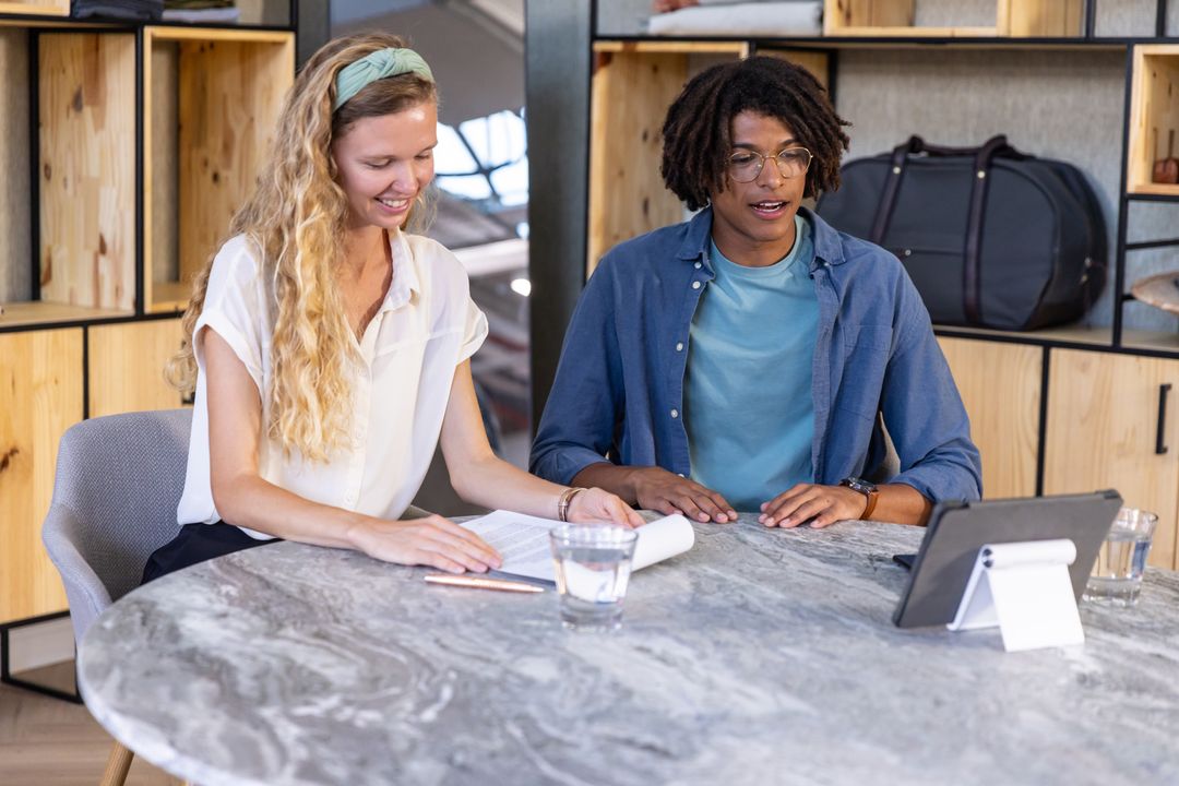 Colleagues Browsing Documents During Collaborative Meeting