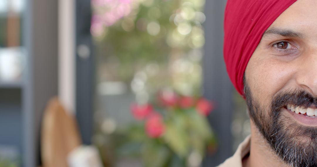 Man in Red Turban Enjoying Relaxed Moment at Home