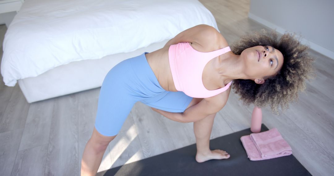 Woman Practicing Yoga at Home in Bright Bedroom