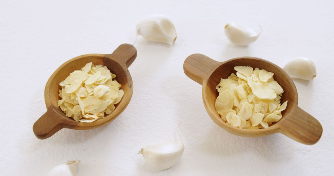 Dried Garlic Flakes in Wooden Bowls with Fresh Cloves - Free Images, Stock Photos and Pictures on Pikwizard.com