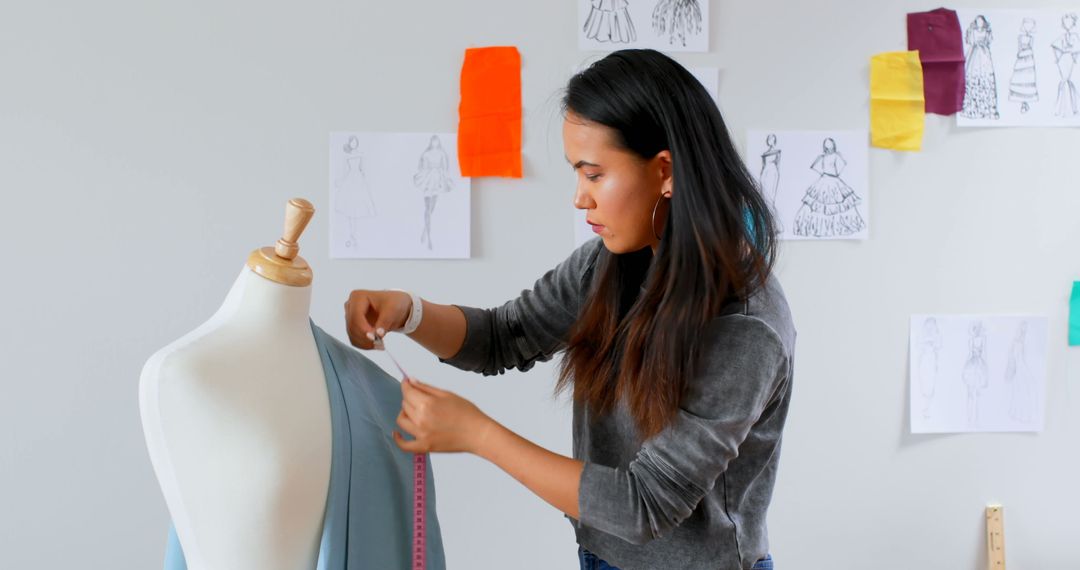 Asian Fashion Designer Measuring Fabric on Mannequin - Free Images, Stock Photos and Pictures on Pikwizard.com