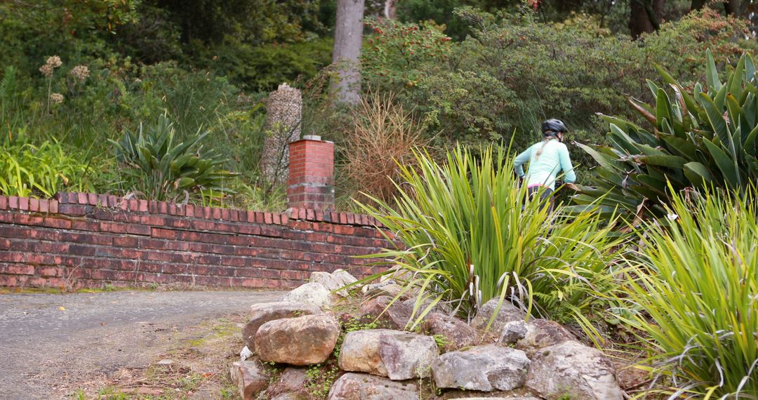 Cyclist Riding Through Lush Path Surrounded By Greenery - Free Images, Stock Photos and Pictures on Pikwizard.com