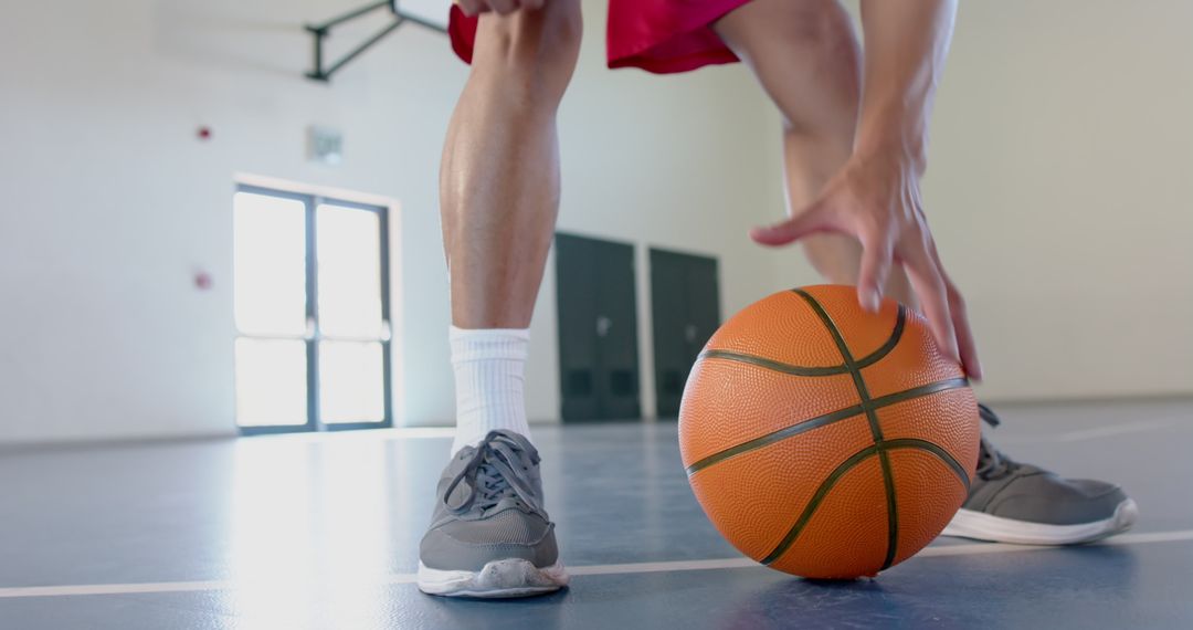 Close-Up of Basketball Player Dribbling on Indoor Court