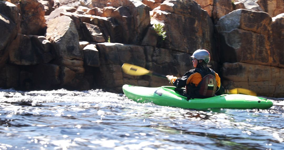 Kayaker Navigating Rapids in Breathtaking Riverscape