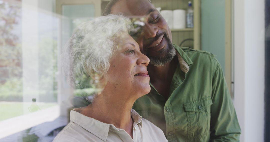 Elderly Couple Embracing Behind Window, Serene Moment of Love and Togetherness - Free Images, Stock Photos and Pictures on Pikwizard.com