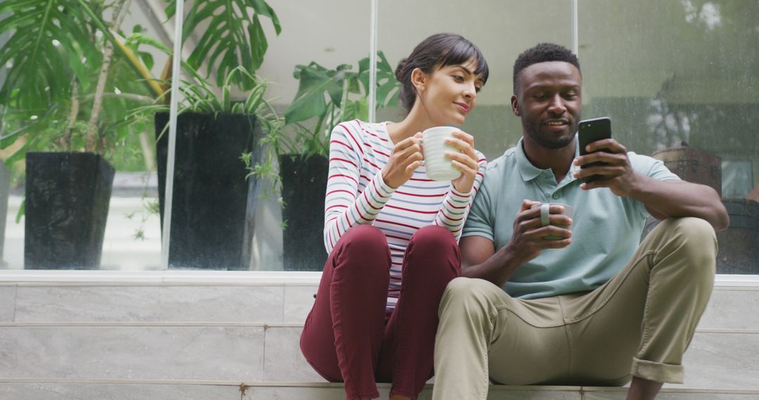 Diverse Couple Enjoying Coffee and Conversation in Garden