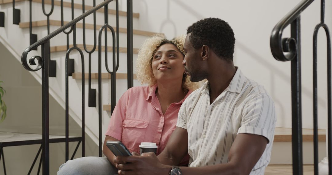 Happy Couple Sharing a Relaxing Moment at Home with Coffee