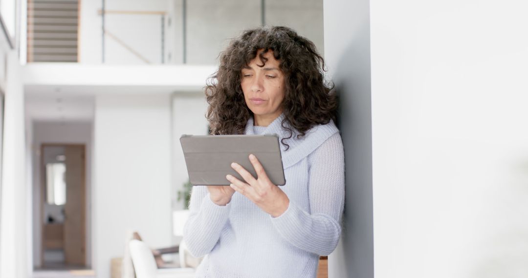 Mature Woman Using Tablet in Bright Home Environment - Free Images, Stock Photos and Pictures on Pikwizard.com