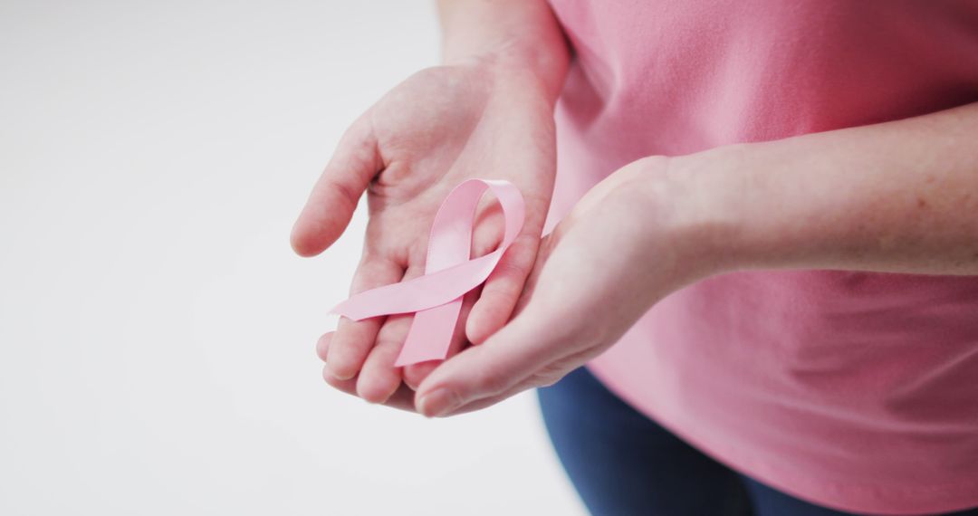 Hands Holding Pink Ribbon Symbolizing Breast Cancer Awareness - Free Images, Stock Photos and Pictures on Pikwizard.com