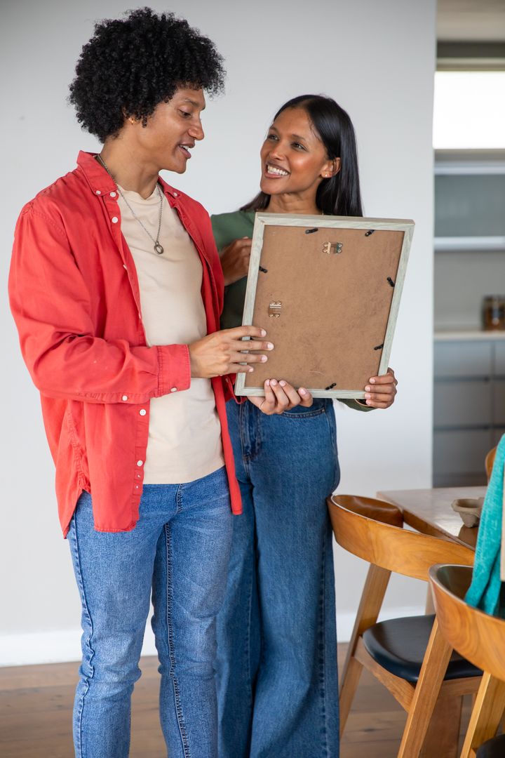 Couple Reviewing Rustic Picture Frame in Cozy Home