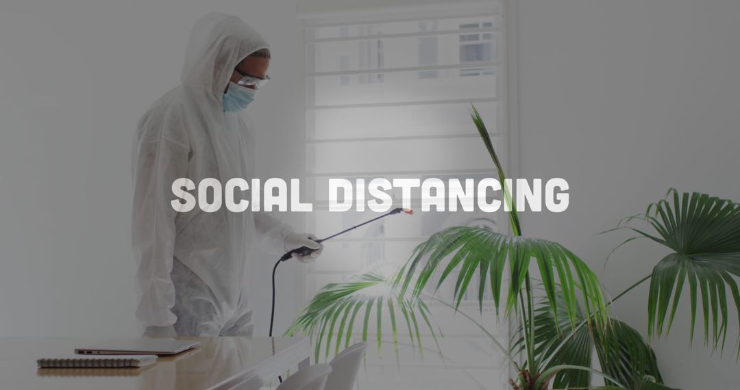 Worker Disinfecting Office with Focus on Social Distancing