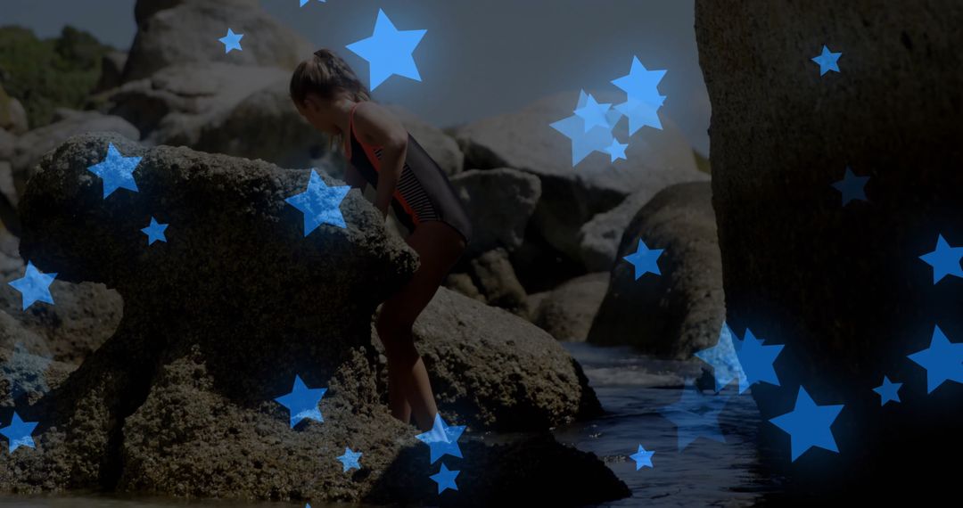 Child Climbing Granite Boulders by Clear Tidal Pool on Summer Day