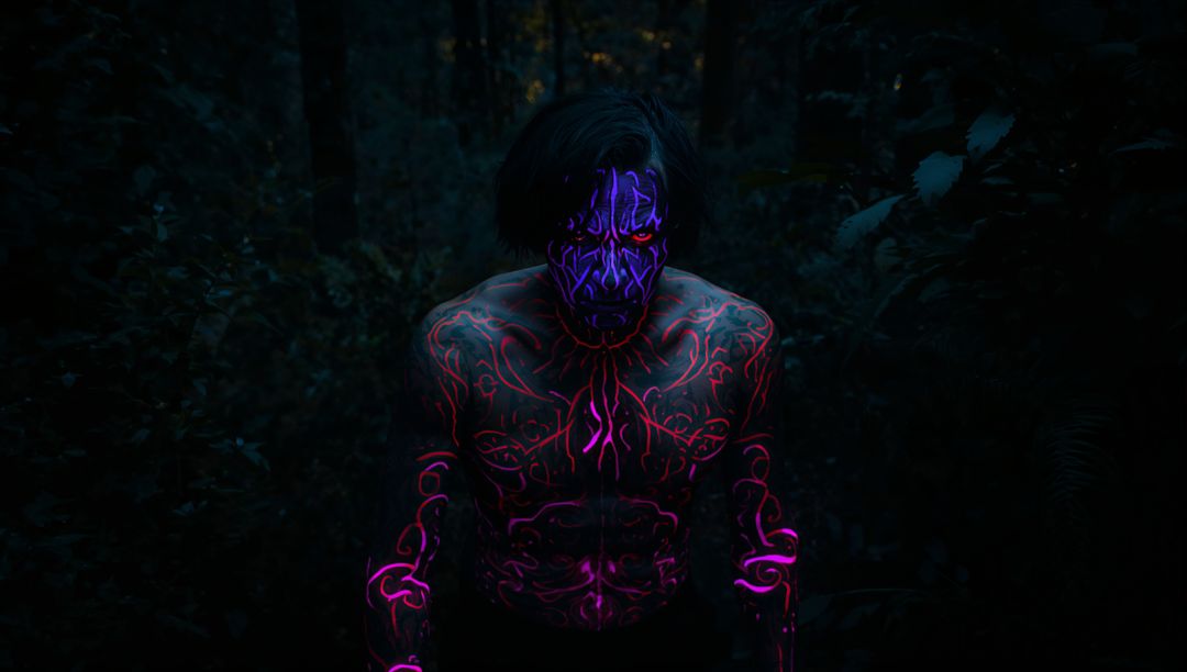 Man with Vivid UV Neon Body Paint in Mysterious Night Forest
