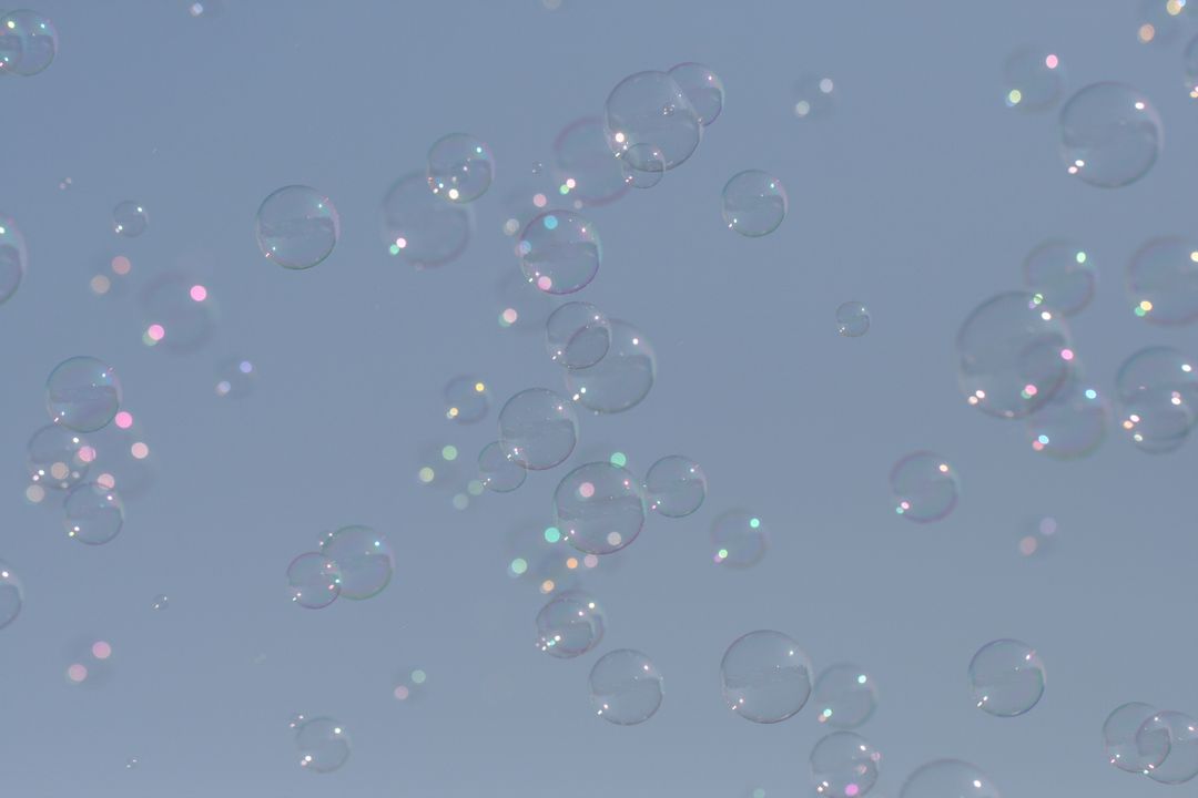 Colorful Soap Bubbles Floating in Clear Blue Sky