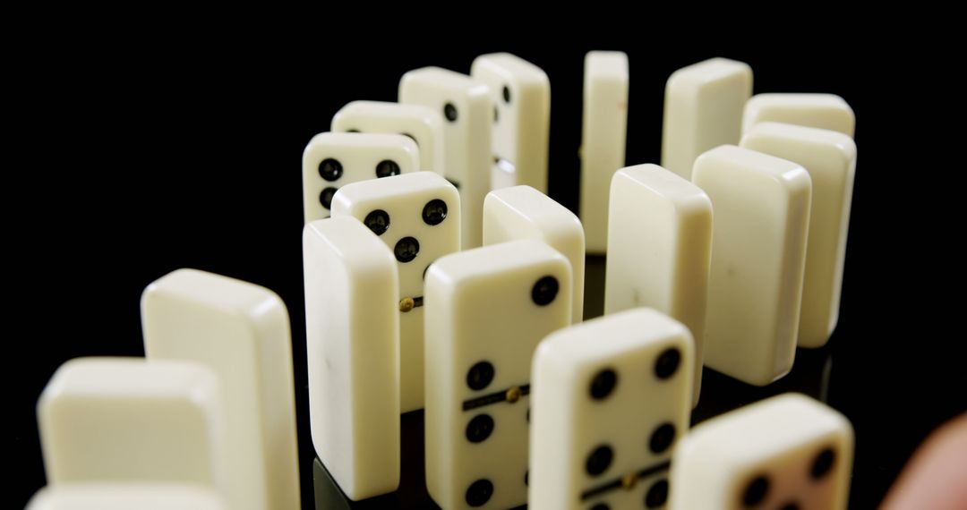 Close-Up of Dominoes Arranged in Semi-Circle on Reflective Surface - Free Images, Stock Photos and Pictures on Pikwizard.com