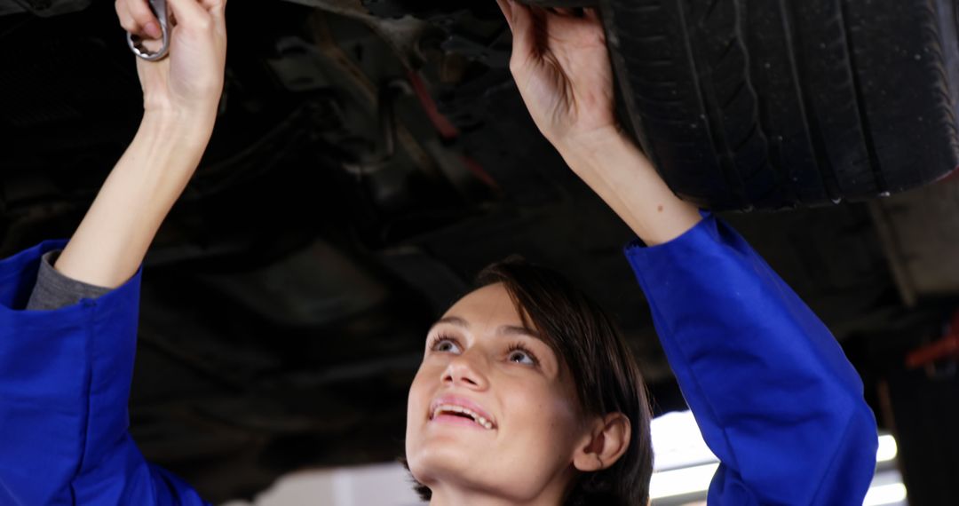 Female Mechanic Repairing Car Under Chassis in Auto Shop - Free Images, Stock Photos and Pictures on Pikwizard.com