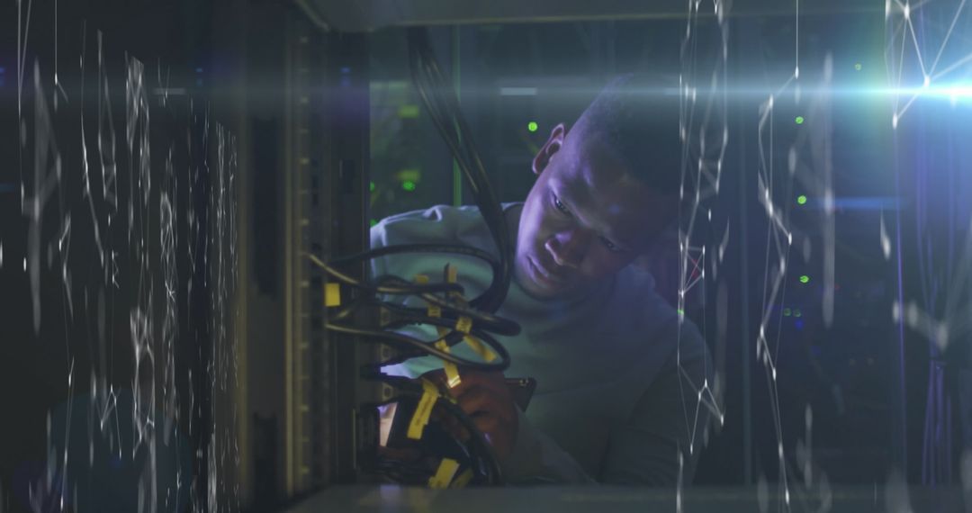 Focused Technician Fixing connections in High-Tech Server Room