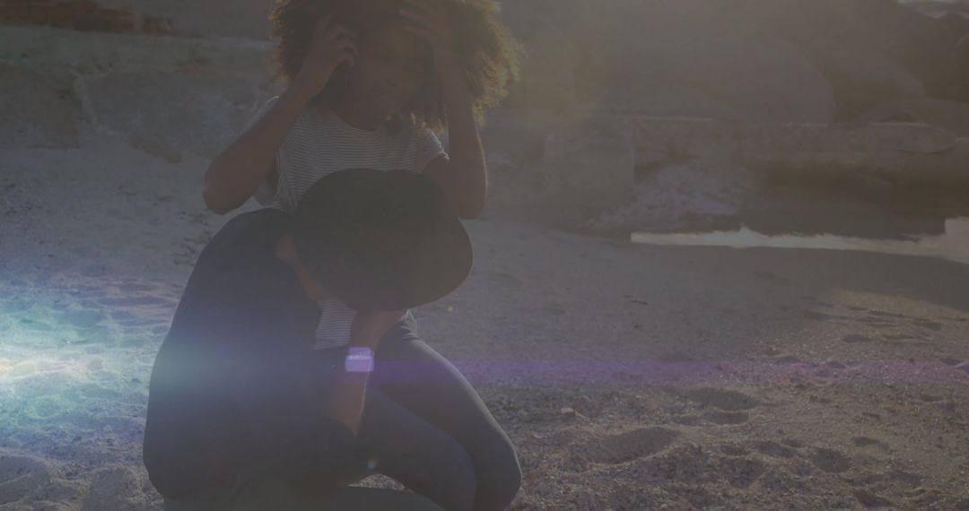 Romantic Evening on Beach with Couple Embracing and Phone