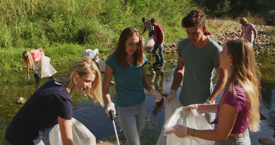 Volunteers Cleaning Riverbank on Sunny Day - Free Images, Stock Photos and Pictures on Pikwizard.com