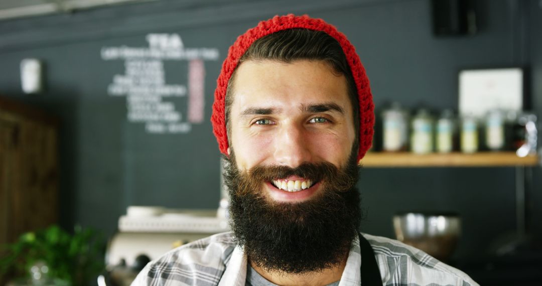 Smiling Bearded Barista with Red Beanie in Coffee Shop - Free Images, Stock Photos and Pictures on Pikwizard.com