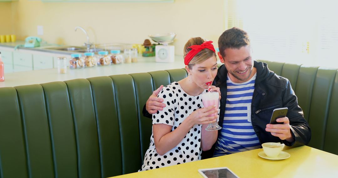 Young couple enjoying milkshake at retro diner - Free Images, Stock Photos and Pictures on Pikwizard.com