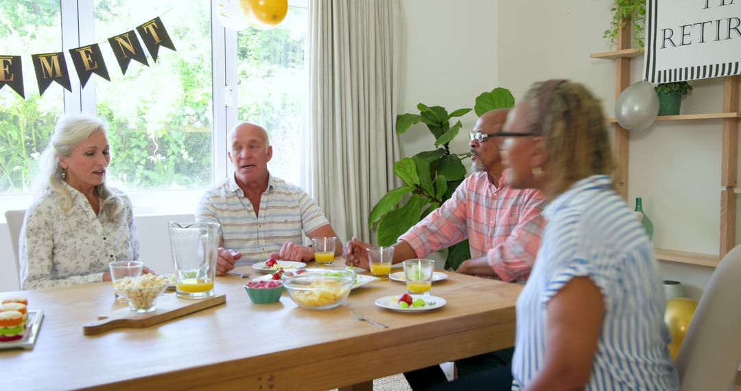 Senior Friends Enjoying a Retirement Celebration at Home