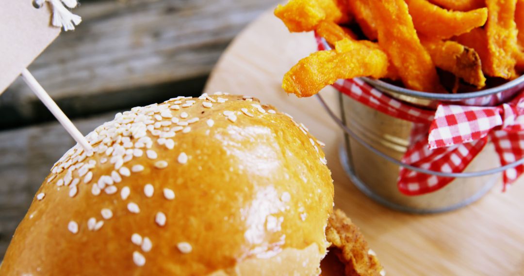 Close-up of Gourmet Burger with Sesame Bun and Sweet Potato Fries - Free Images, Stock Photos and Pictures on Pikwizard.com