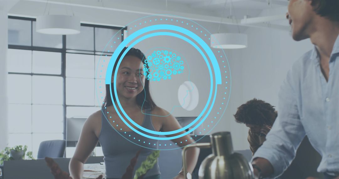 Smiling Asian woman collaborating with team in modern office with futuristic HUD overlay