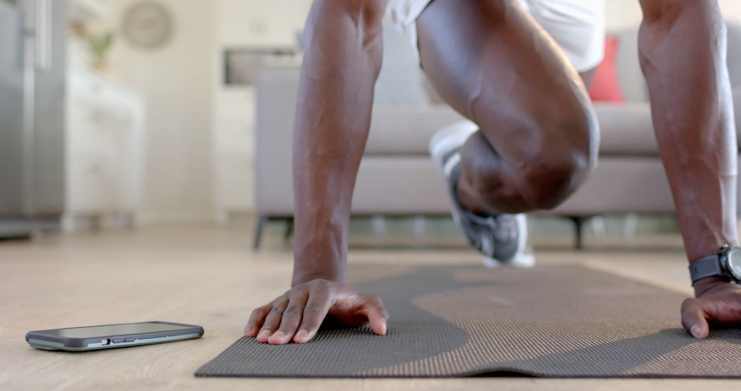 Athlete Performing Push-ups with Smartphone on Floor for Workout Routine Tutorial - Free Images, Stock Photos and Pictures on Pikwizard.com