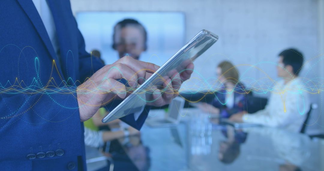 Businessman Utilizing Digital Tablet Amid Team Meeting in Office