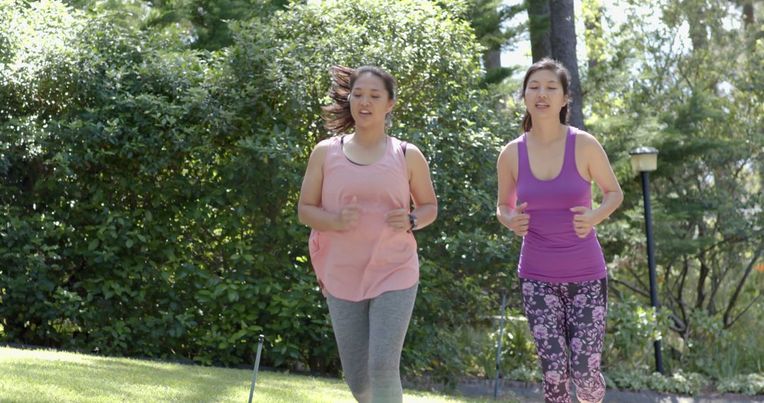 Two Women Jogging in Park on a Sunny Day - Free Images, Stock Photos and Pictures on Pikwizard.com