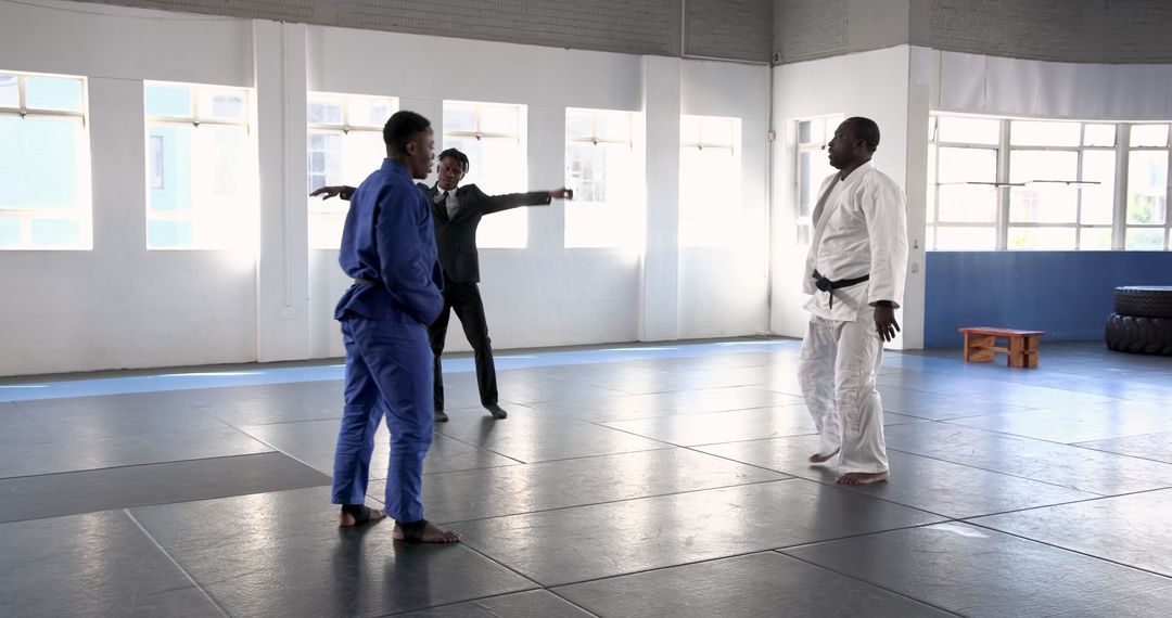 Martial Arts Training with Instructor and Students in Bright Dojo