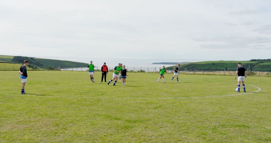 Team Soccer Practice on Coastal Field with Vibrant Backdrop