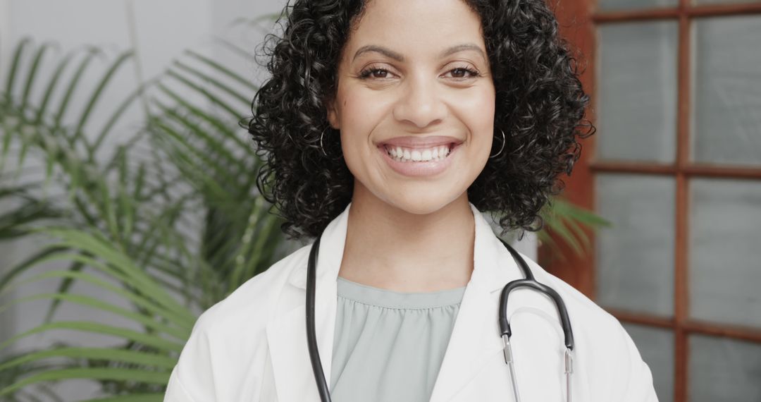 Confident Female Doctor Smiling with Stethoscope - Free Images, Stock Photos and Pictures on Pikwizard.com