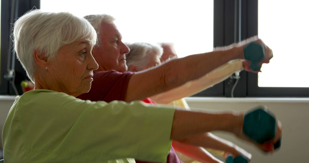 Seniors Performing Group Exercise with Dumbbells in Class - Free Images, Stock Photos and Pictures on Pikwizard.com