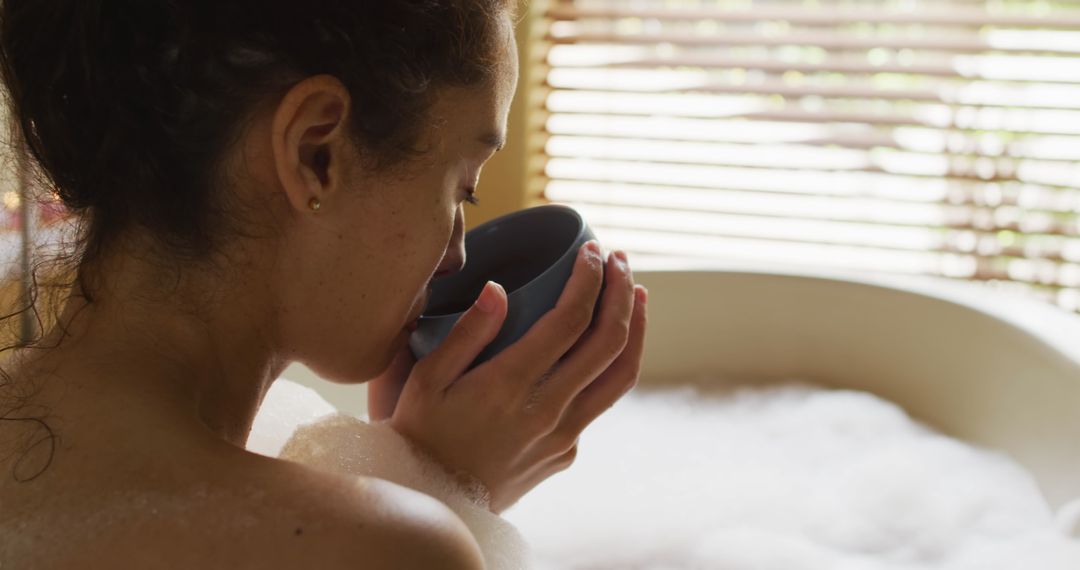 Woman Relaxing with Coffee in Bathtub with Foam