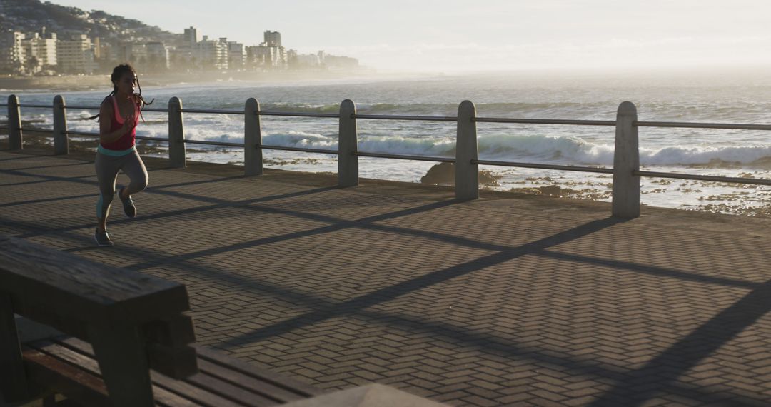 Woman Jogging Along Waterfront Promenade at Sunrise - Free Images, Stock Photos and Pictures on Pikwizard.com