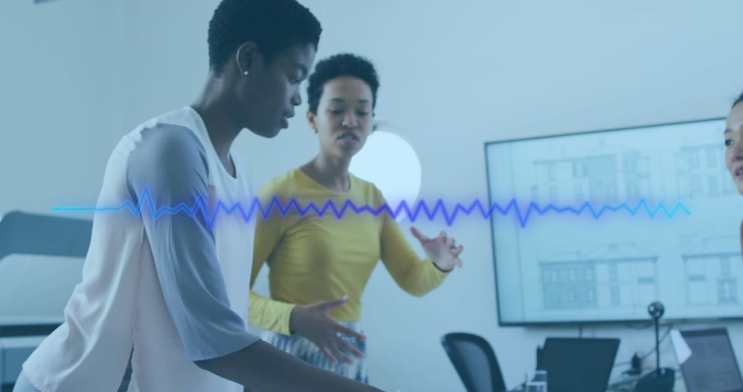 Diverse Female Team Collaborating in Tech-Driven Office Environment