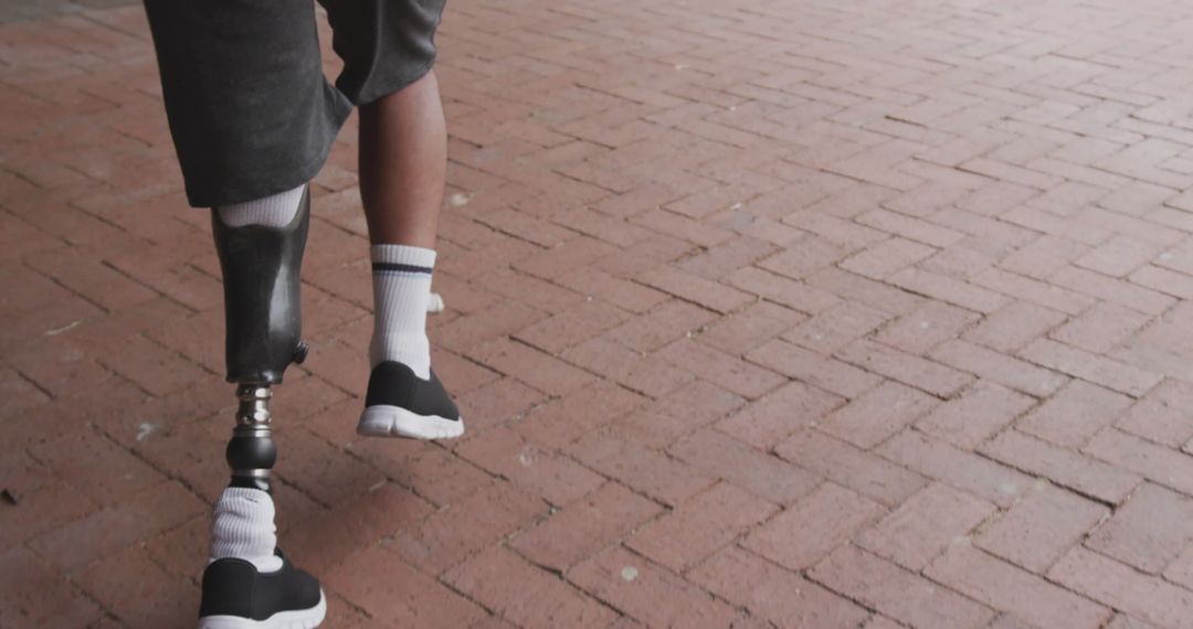 Inspirational Journey of Man with Prosthetic Leg on Brick Path