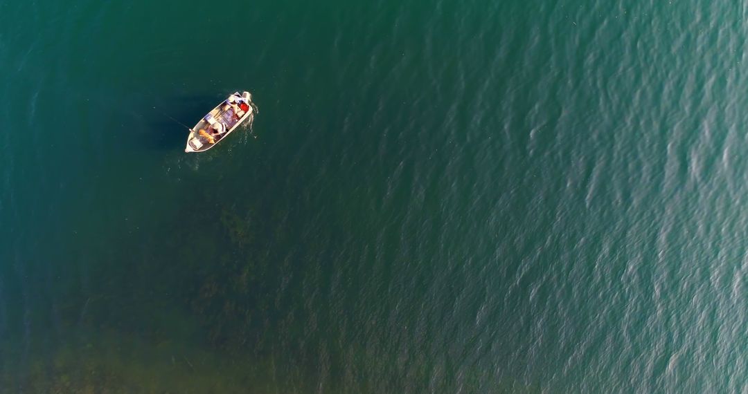 Aerial View of Fishermen in Small Boat on Calm Lake Water - Free Images, Stock Photos and Pictures on Pikwizard.com