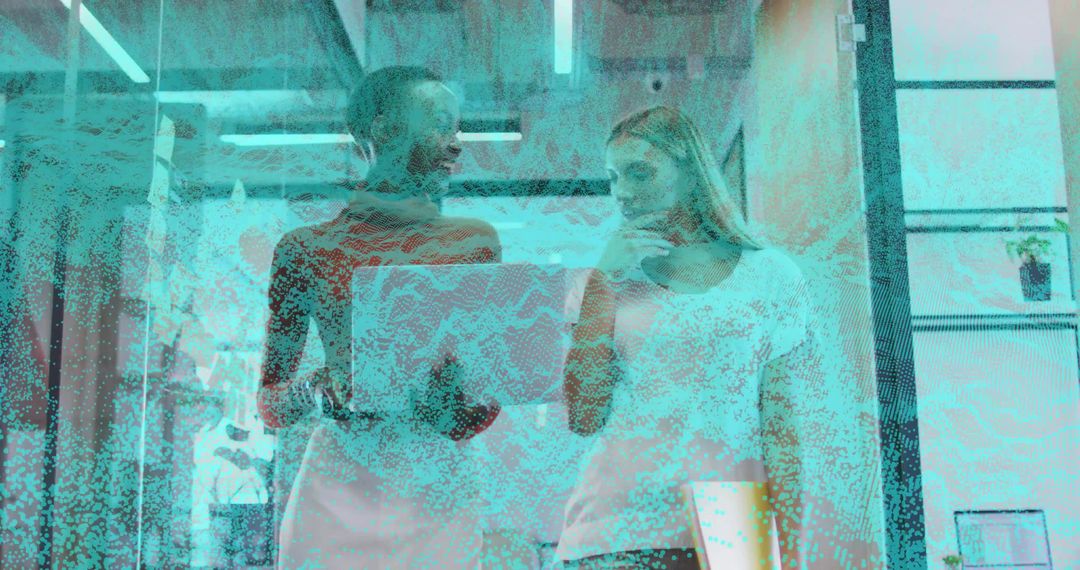 Colleagues Reviewing Laptop Collaboration in Modern Office