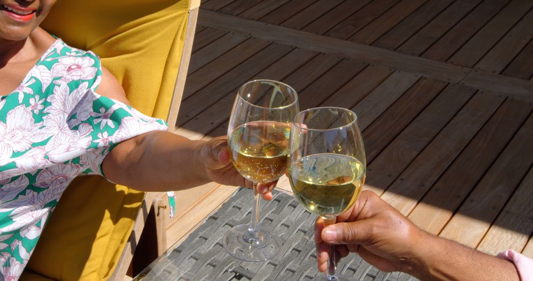 Couple Toasting with White Wine on Sunny Wooden Deck - Free Images, Stock Photos and Pictures on Pikwizard.com