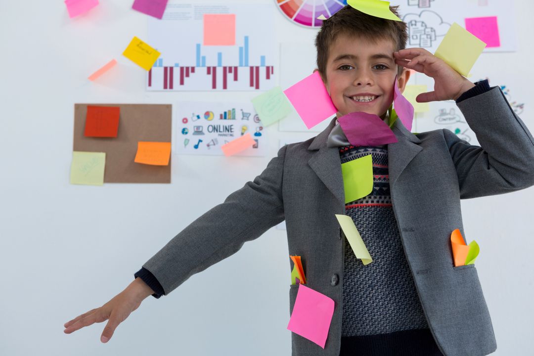 Boy as business executive with sticky notes on his body - Free Images, Stock Photos and Pictures on Pikwizard.com