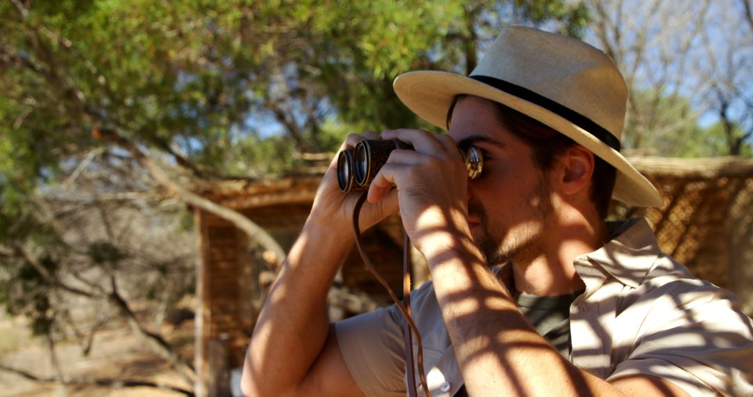 Young Male Explorer Looking Through Binoculars in Nature - Free Images, Stock Photos and Pictures on Pikwizard.com