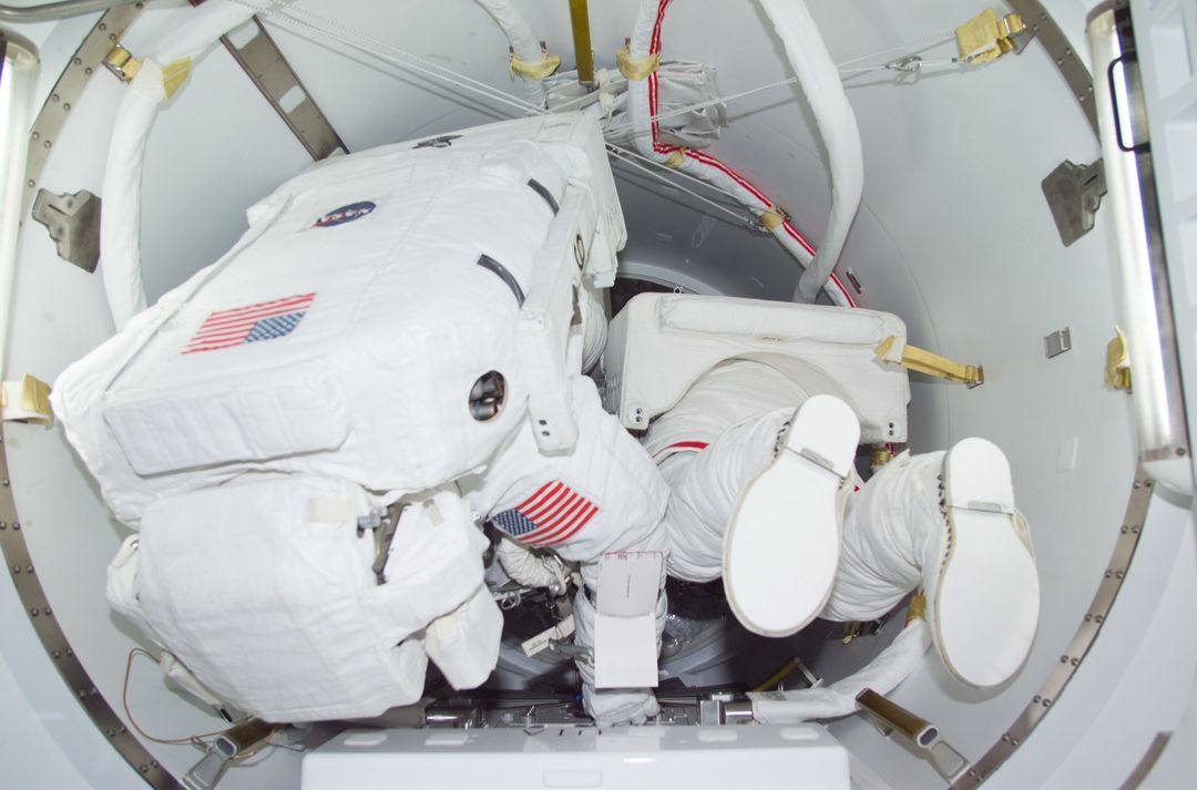Astronauts Preparing for Spacewalk in Crew Lock Compartment - Free Images, Stock Photos and Pictures on Pikwizard.com