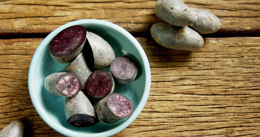 Purple Sweet Potatoes in Blue Bowl on Rustic Wooden Table - Free Images, Stock Photos and Pictures on Pikwizard.com