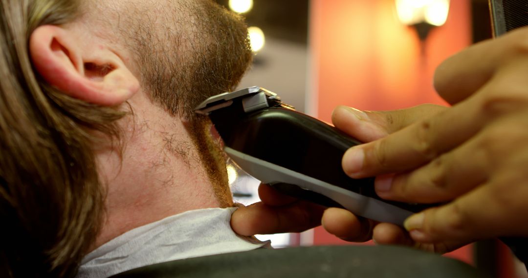 Close-Up Barbershop Beard Trim with Electric Clippers - Free Images, Stock Photos and Pictures on Pikwizard.com