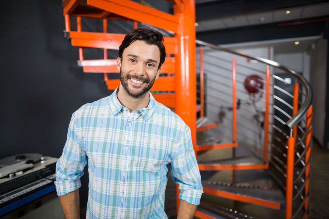 Smiling Man Standing in Modern Studio with Vibrant Design Elements